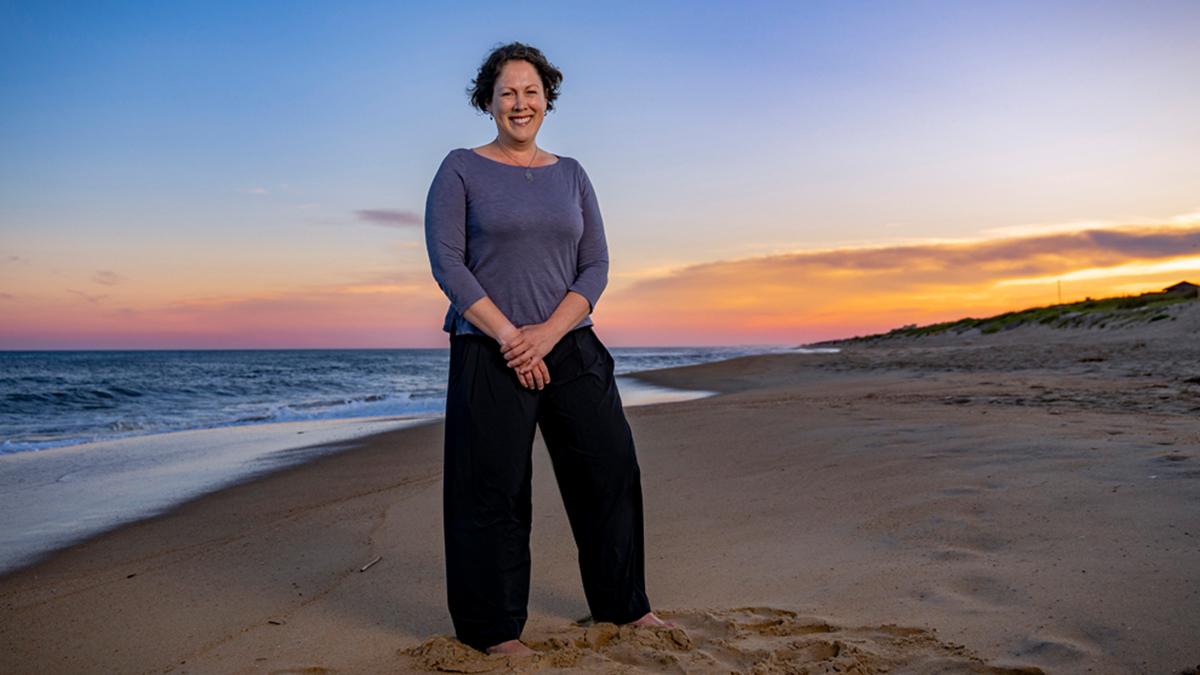 Megan Mendenhall posing on the beach at dusk.